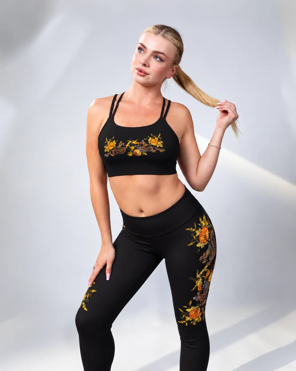 Model wearing the Dragon Gold bra with gilded dragon and rose embroidery