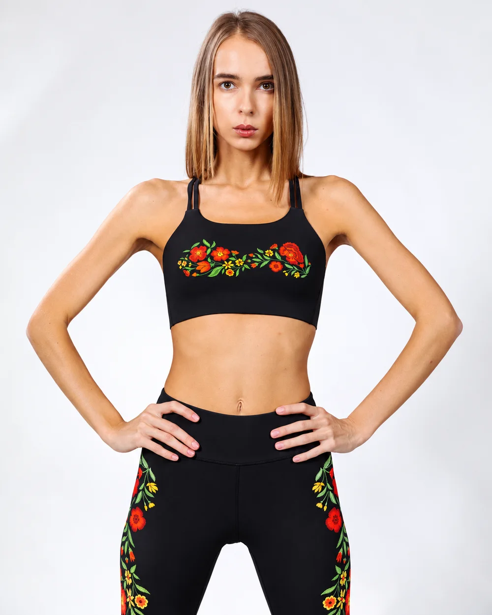 Model wearing the Poppy Field bra with red poppy embroidery across the chest